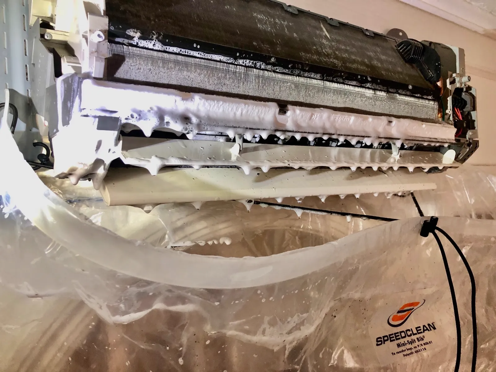 Mini-split deep cleaning Brooklyn — SpeedClean foam dripping off the coil during a wall-mounted unit deep clean