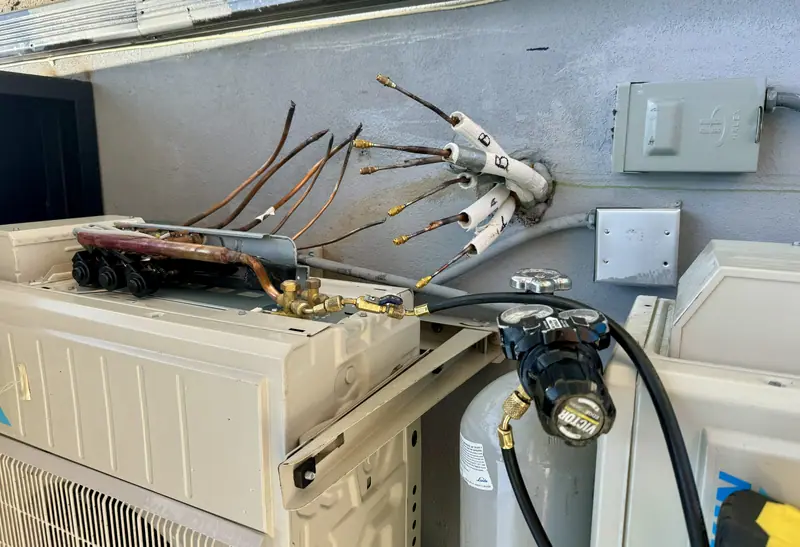 Close-up of copper line set fittings during an isolation test
