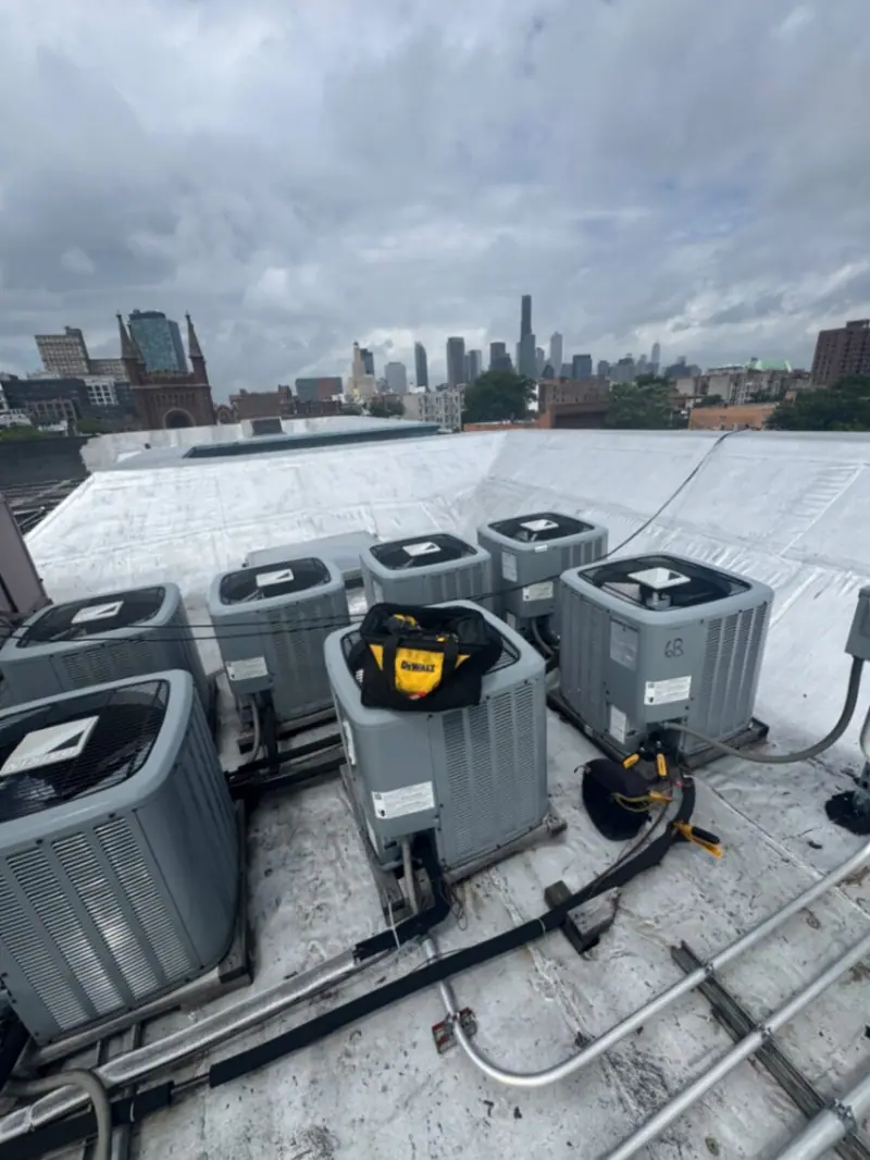 Brooklyn HVAC installation — multi-unit rooftop condenser array with downtown Brooklyn skyline