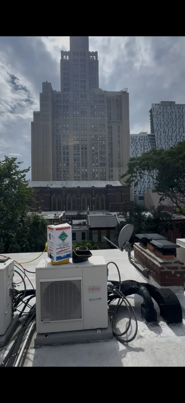 Brooklyn mini-split installation — Fujitsu rooftop condenser near the Williamsburgh Savings Bank tower