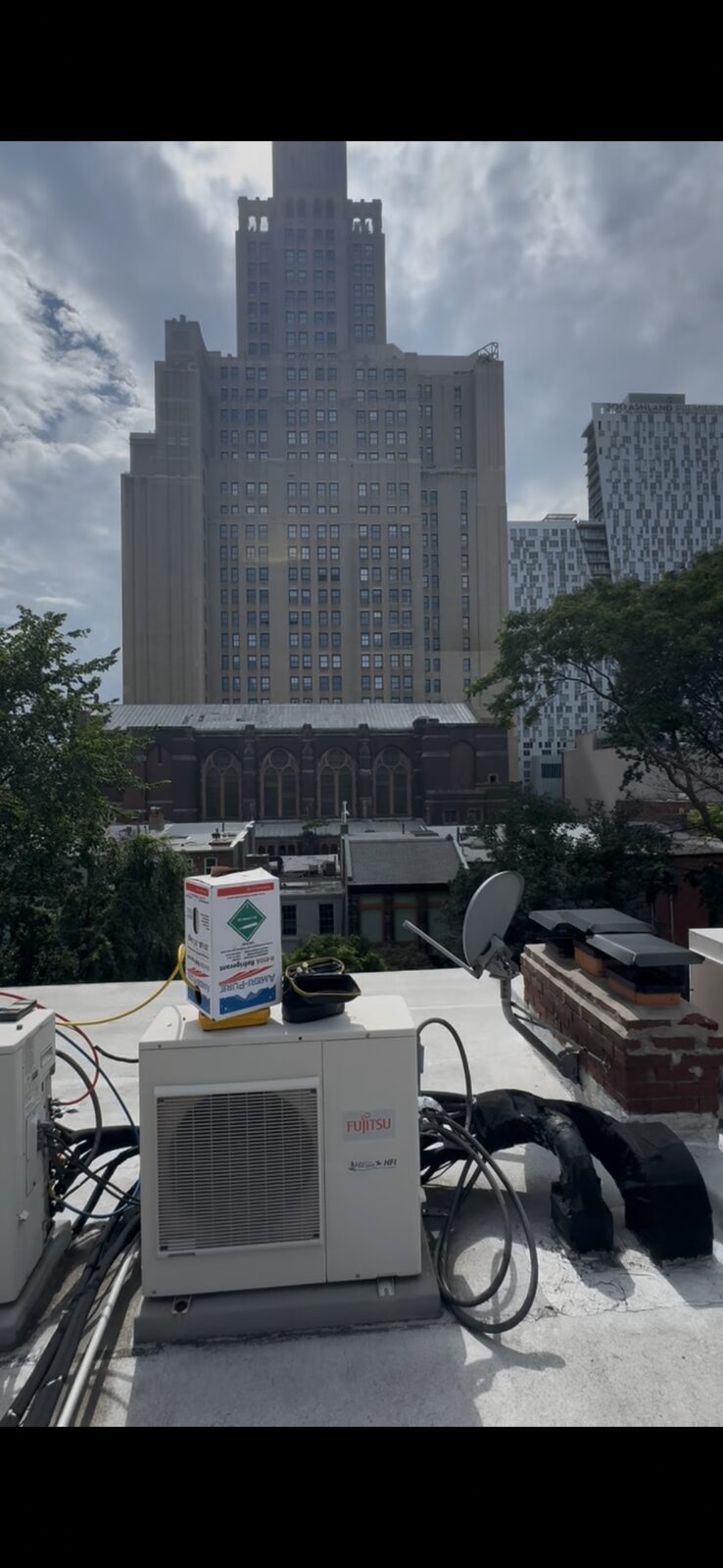 Brooklyn mini-split installation — Fujitsu rooftop condenser near the Williamsburgh Savings Bank tower
