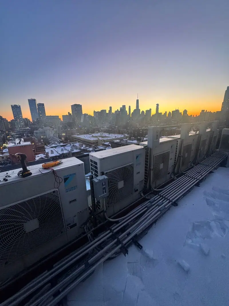 Rooftop condenser units with the Manhattan skyline behind